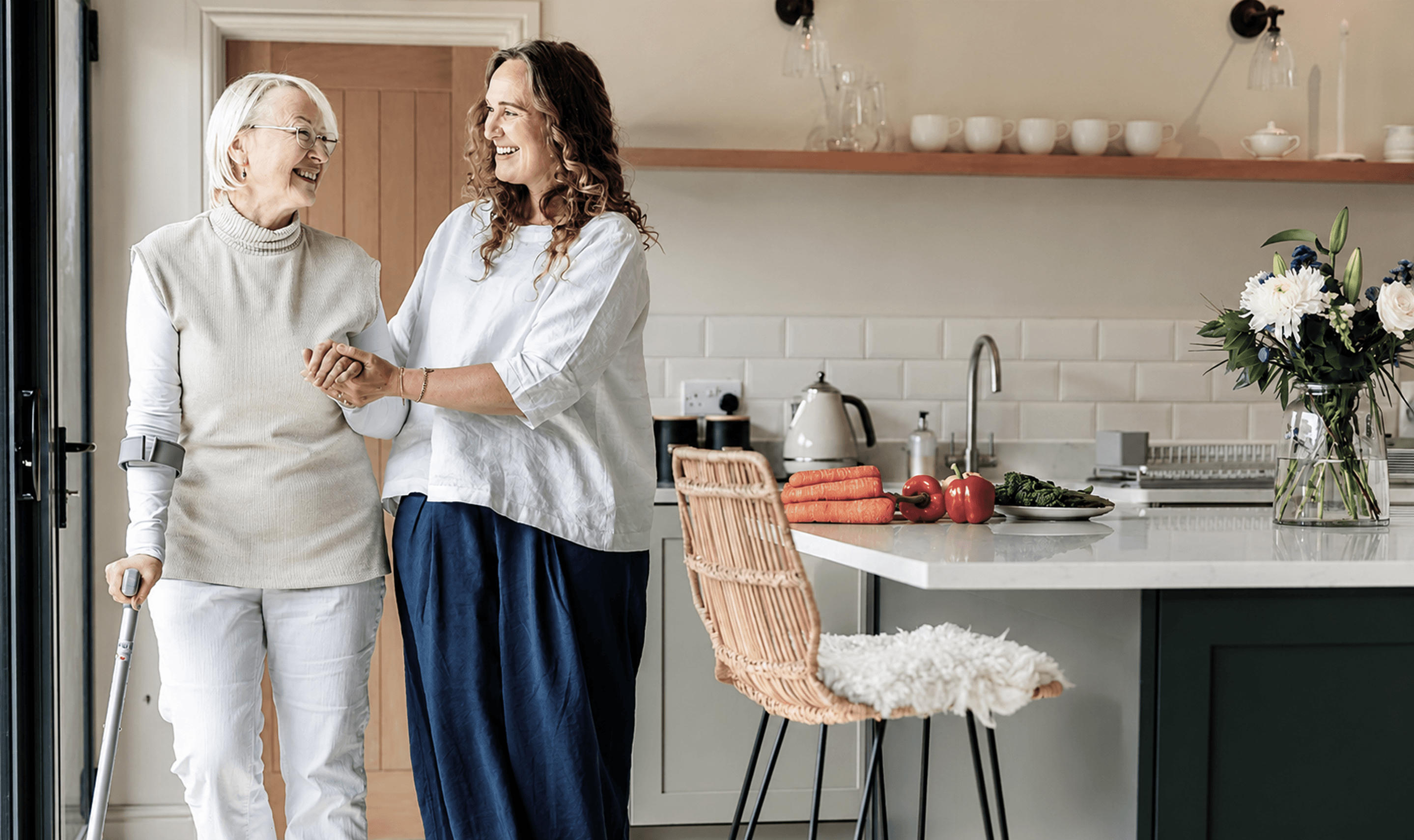 Caregiver walking with senior resident at home